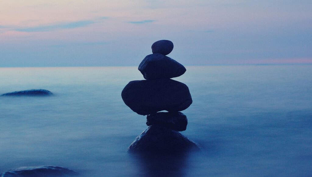 pexels photo 267950 267950 A calming seascape featuring stacked stones at twilight, symbolizing balance and tranquility.